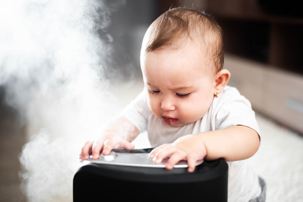 kid playing with humidifier