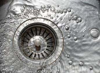 Water swirling down a drain in an Orlando home