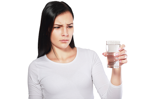 Woman holding a glass of water